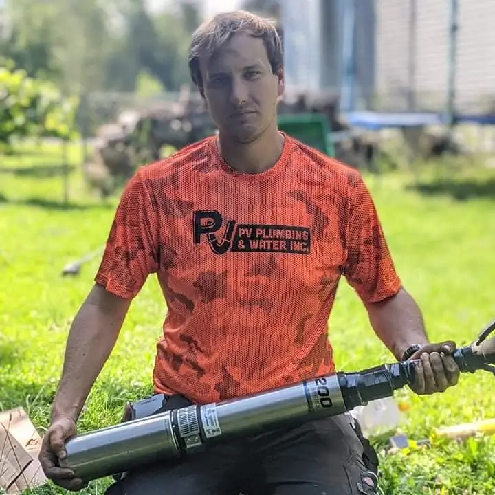 Well Technician holding a Franklin Water Submersible Well Pump.