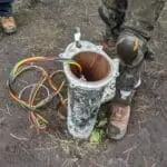 Well Technician from PV Plumbing & Water Inc next to a water well.