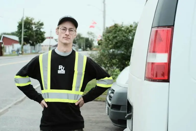 PV Well Technician next to service van.