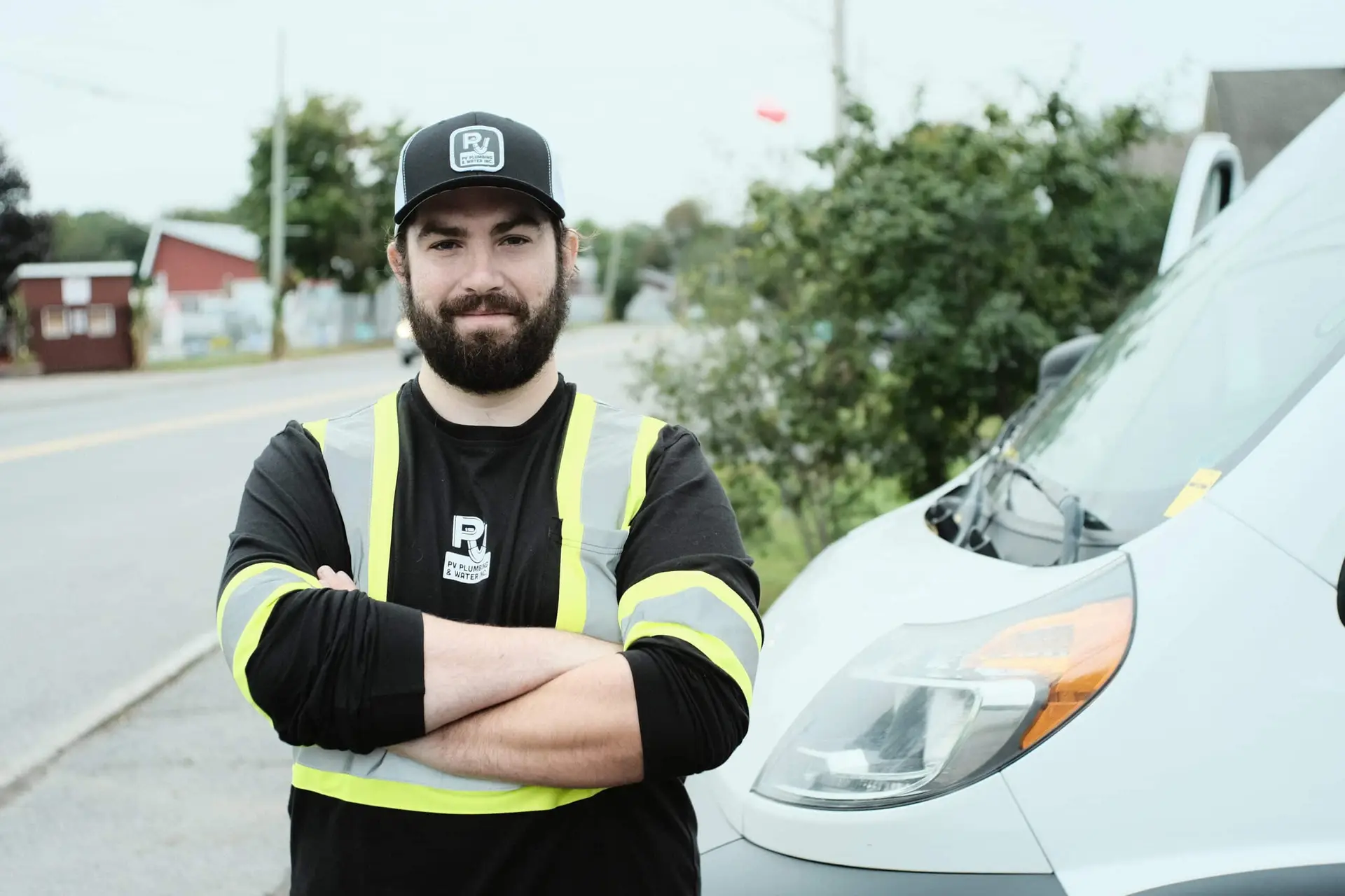 PV Plumbing & Water Inc. employee stands by service van.